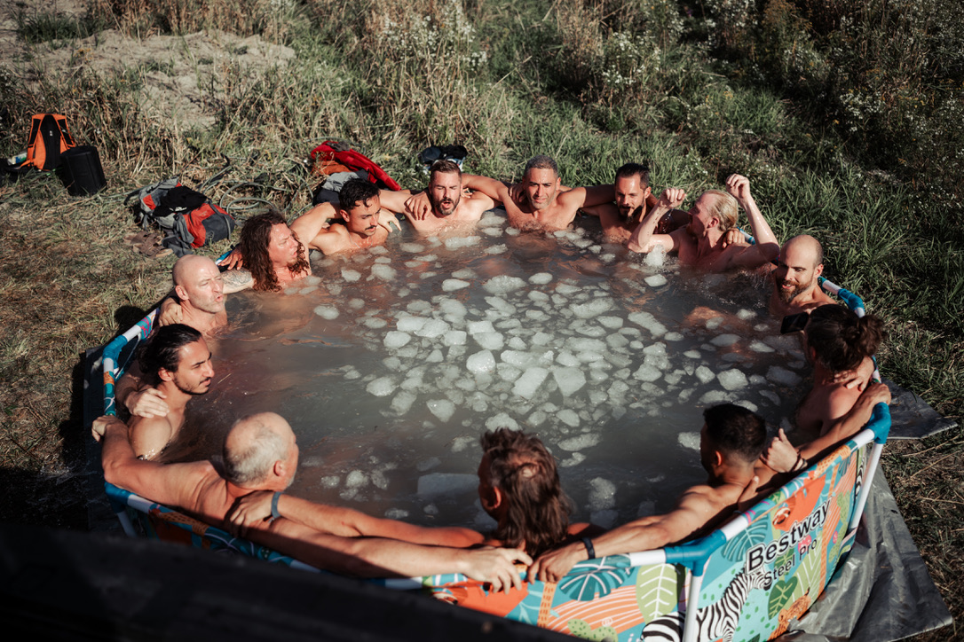 Men in ice cold plunge tub at a festival